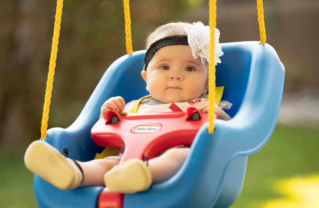 Baby girl in a swing