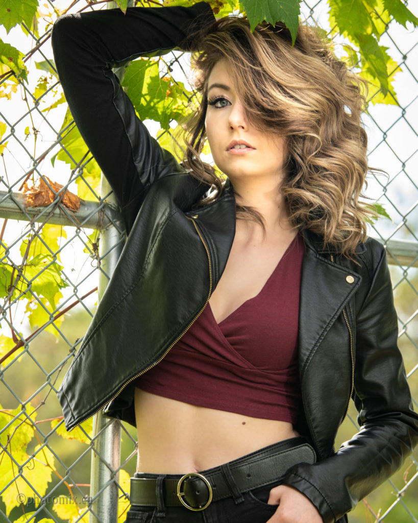 Beautiful model outdoors with fence background