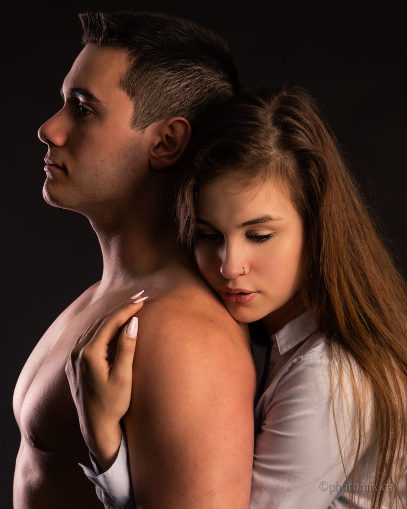 Couple with man bare-chested studio lighting