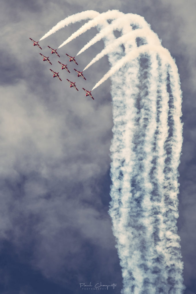 Snowbirds flying with clouds in the background